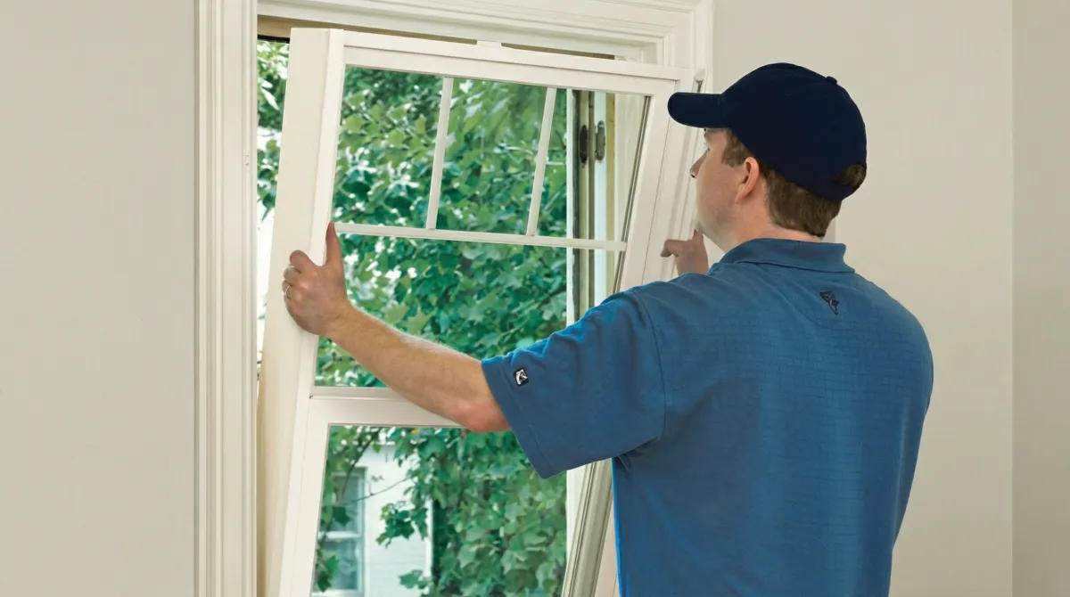 Professional contractors performing a residential window insulation and replacement service in Lowell, MA